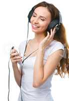 Young woman enjoying music using headphones