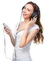 Young woman enjoying music using headphones