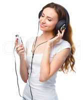 Young woman enjoying music using headphones