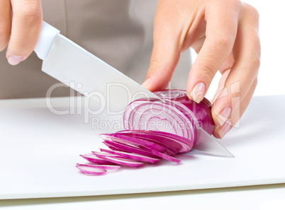 Cook is chopping onion