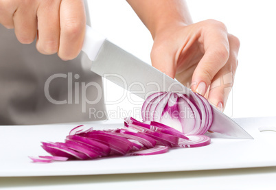 Cook is chopping onion