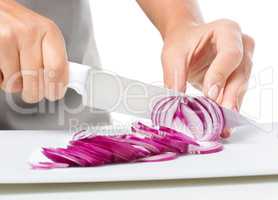 Cook is chopping onion