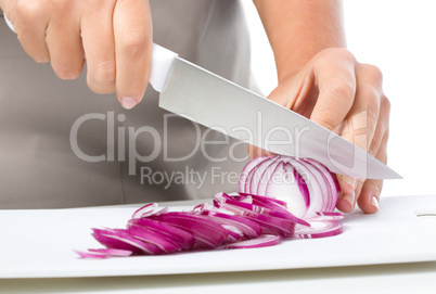 Cook is chopping onion