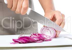 Cook is chopping onion