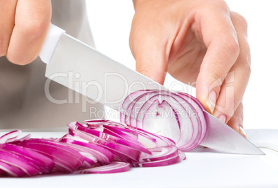 Cook is chopping onion