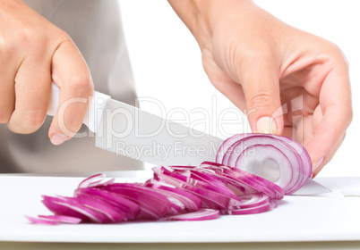 Cook is chopping onion