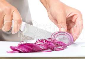 Cook is chopping onion