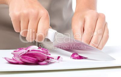 Cook is chopping onion