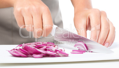 Cook is chopping onion