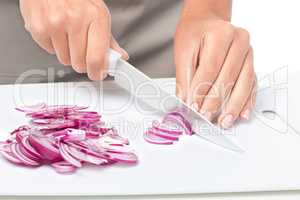 Cook is chopping onion