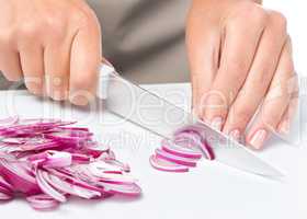 Cook is chopping onion