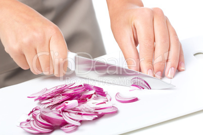 Cook is chopping onion