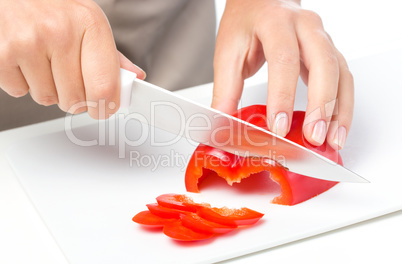 Cook is chopping bell pepper