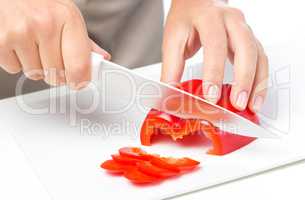 Cook is chopping bell pepper