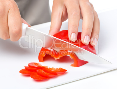 Cook is chopping bell pepper