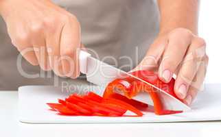 Cook is chopping bell pepper