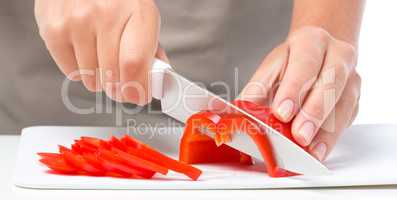 Cook is chopping bell pepper