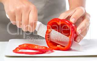 Cook is chopping bell pepper