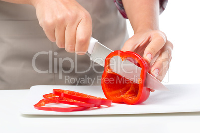 Cook is chopping bell pepper