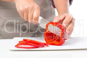 Cook is chopping bell pepper