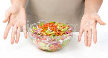 Cook is presenting fresh salad