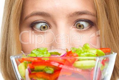 Woman is looking at salad