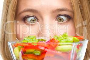 Woman is looking at salad
