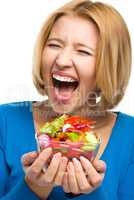 Young happy woman with salad