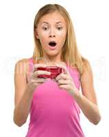Young teen girl is reading sms message
