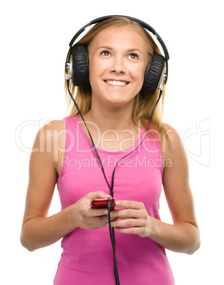 Teen girl enjoying music using headphones