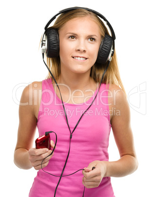 Teen girl enjoying music using headphones