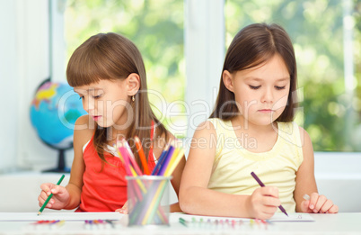 Little girls are drawing using pencils