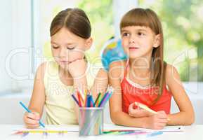 Little girls are drawing using pencils