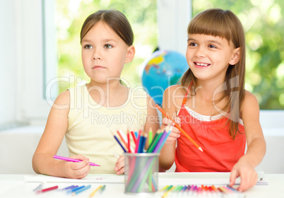 Little girls are drawing using pencils
