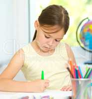 Cute cheerful child drawing using felt-tip pen