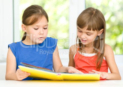 Little girls are reading book