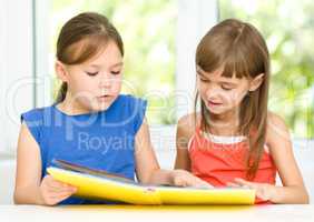 Little girls are reading book