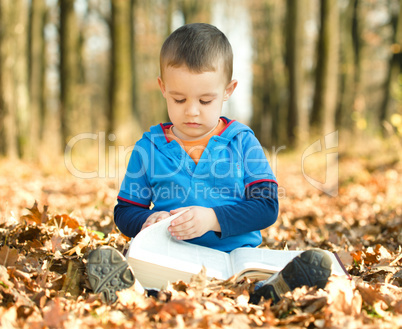 Little boy is reading book