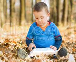 Little boy is reading book