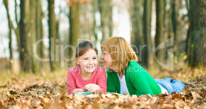 Mother is reading book with her daughter