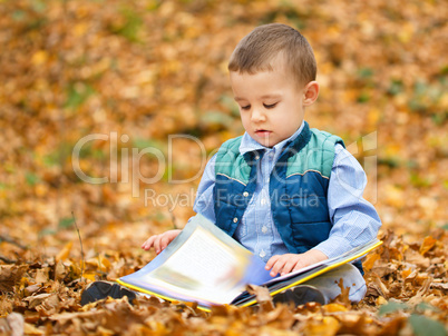 Little boy is reading book