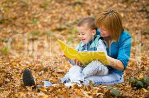 Mother is reading book with her son