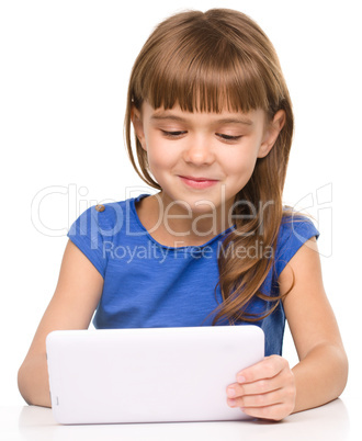 Young cheerful girl is using tablet