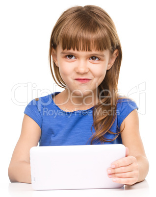 Young cheerful girl is using tablet