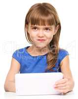 Young cheerful girl is using tablet