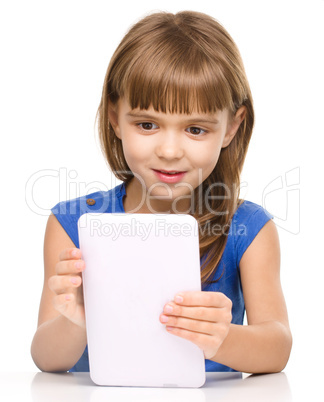 Young cheerful girl is using tablet