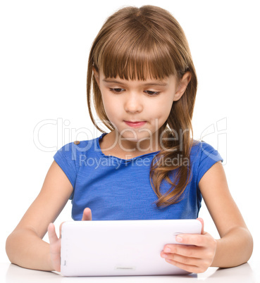 Young girl is using tablet while studying