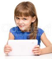 Young cheerful girl is using tablet