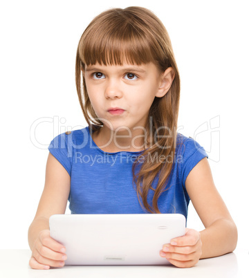 Young girl is using tablet while studying