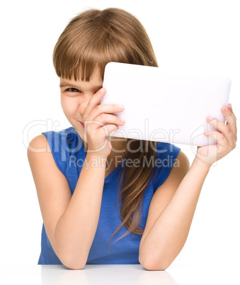 Young cheerful girl is using tablet